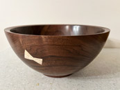 Brad Miller - Walnut bowl with Bow Tie to Cover Flaw.